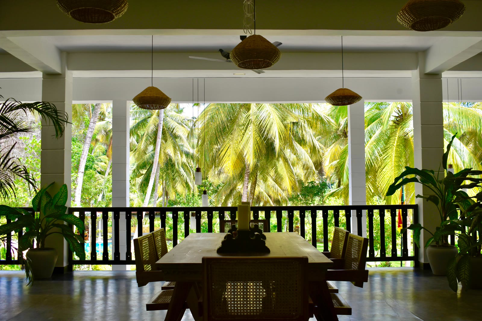 Veranda dining overlooking the coconut palms at Breathe Collections
