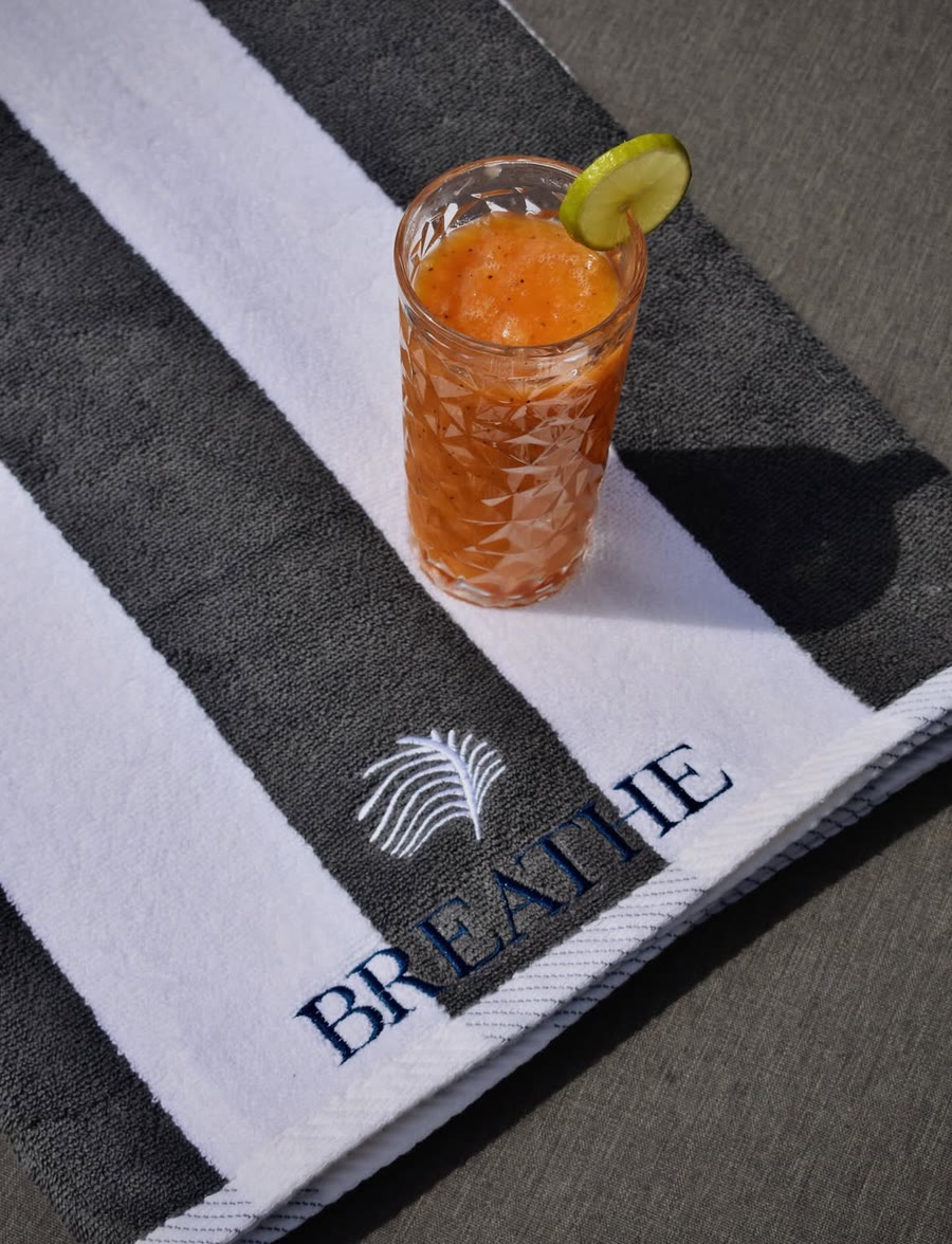 Fresh tropical juice served poolside at Breathe Collections