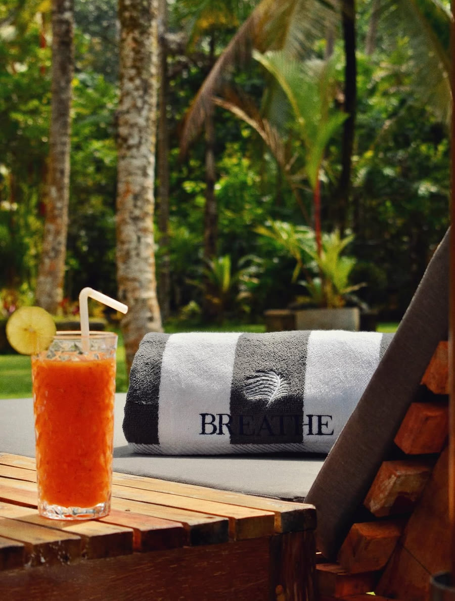 Poolside daybed with fresh juice at Breathe Collections