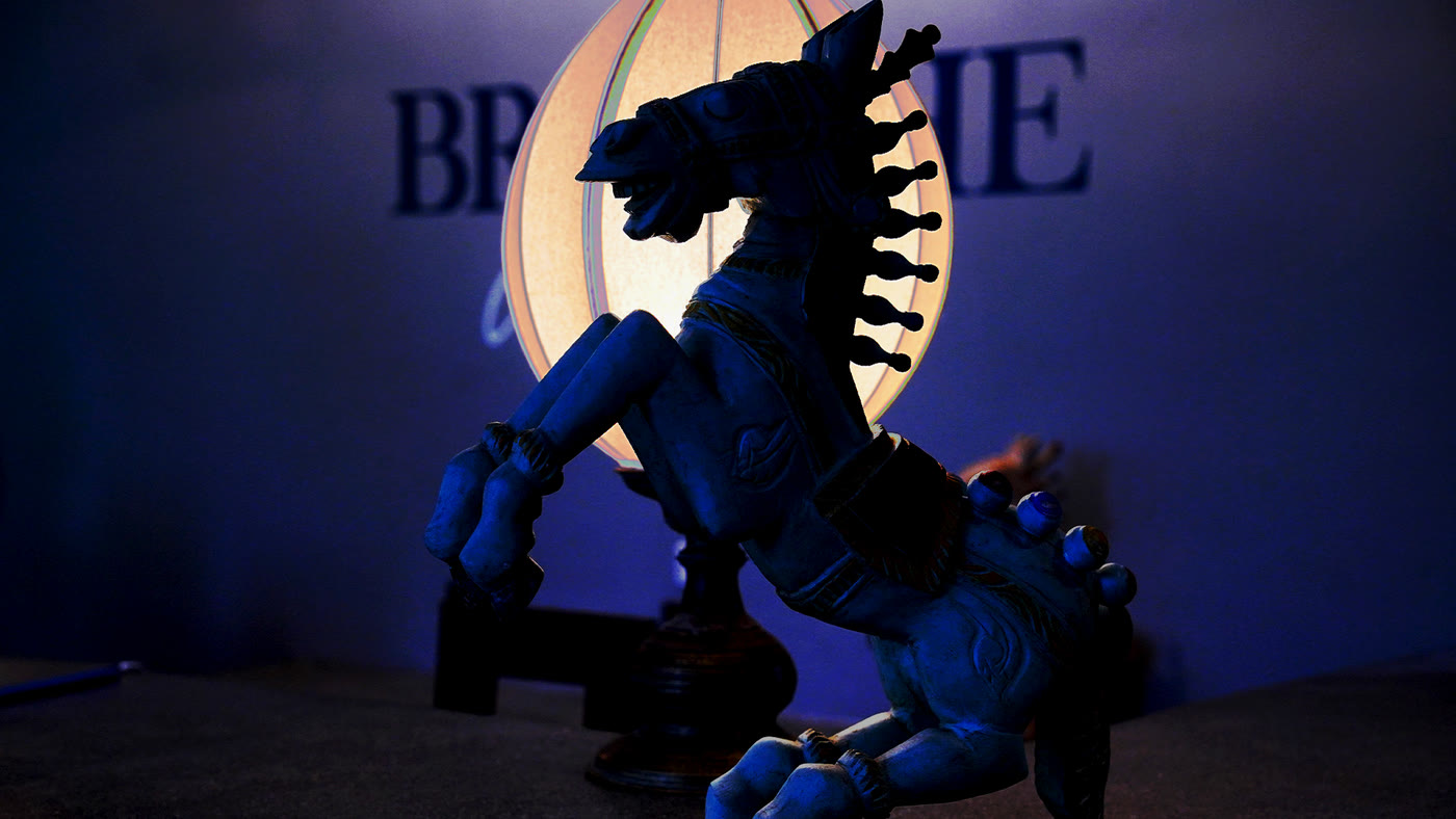 Carved horse sculpture in blue evening light at Breathe Collections