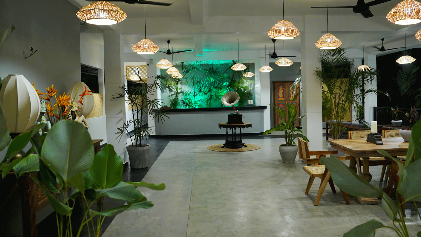 Lobby with lanterns, plants and aquarium at night, Breathe Collections