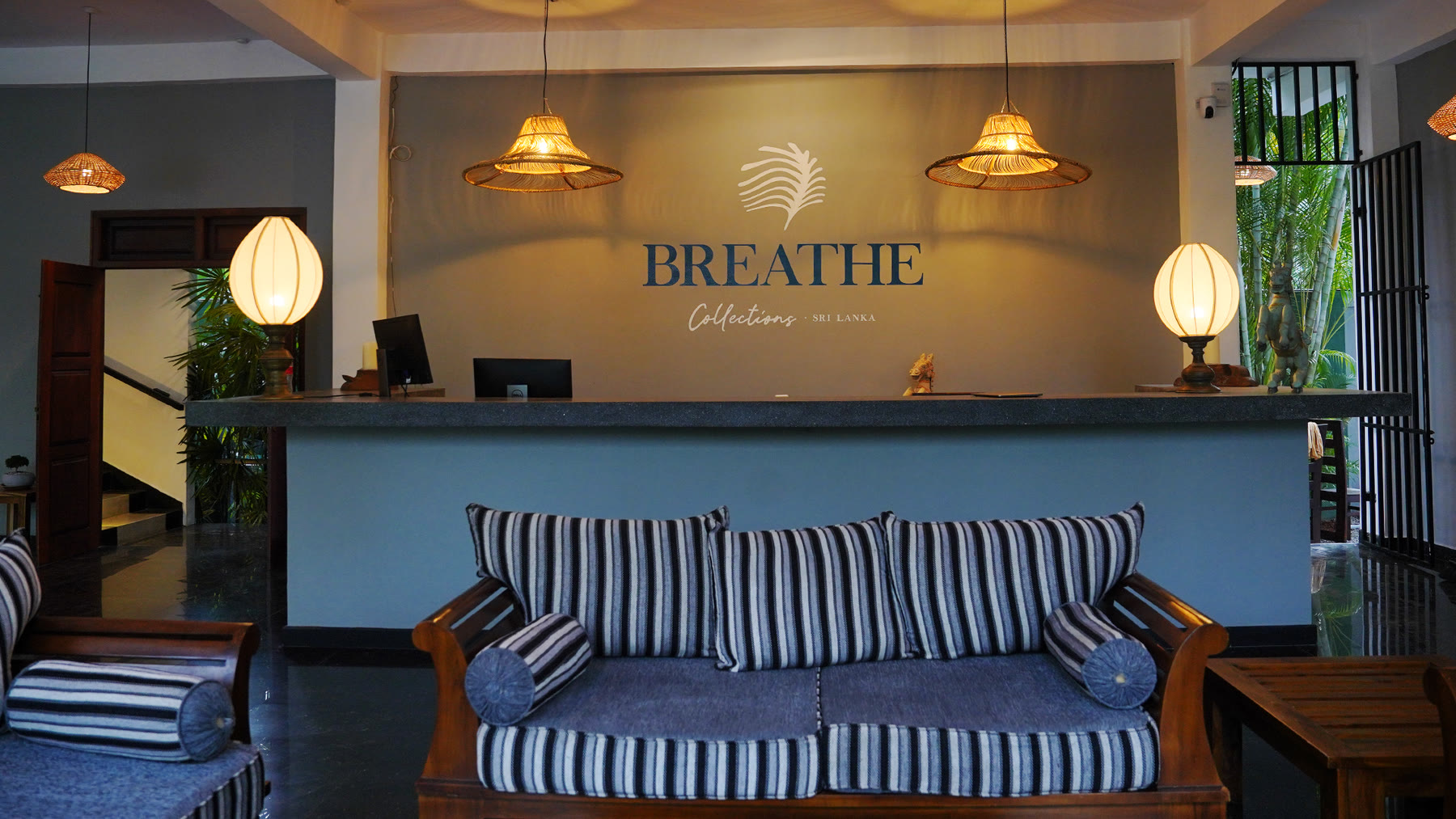Reception lounge with Breathe Collections brand wall — boutique hotel Sri Lanka