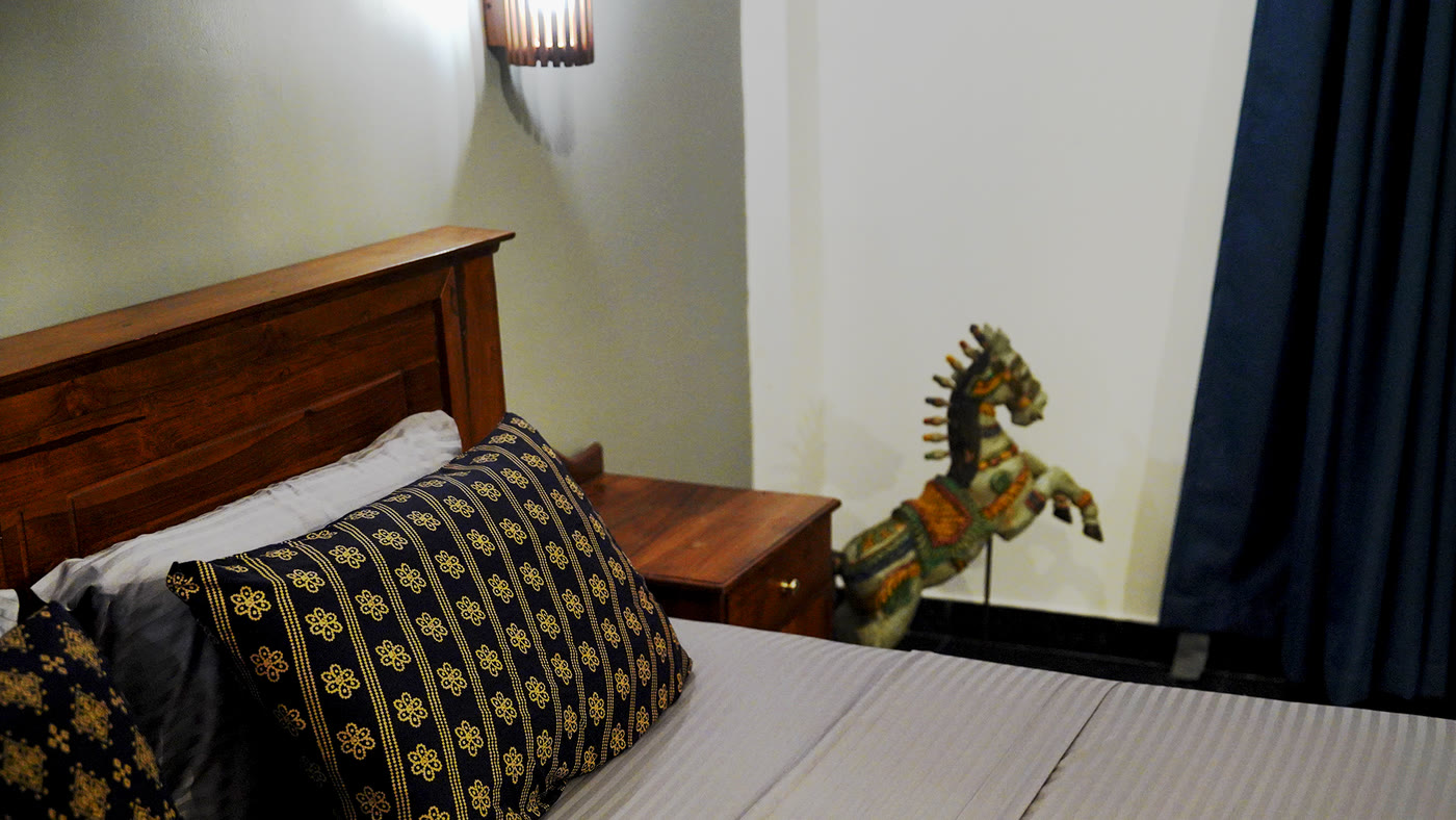 Bedroom detail with carved wooden horse, boutique hotel Sri Lanka